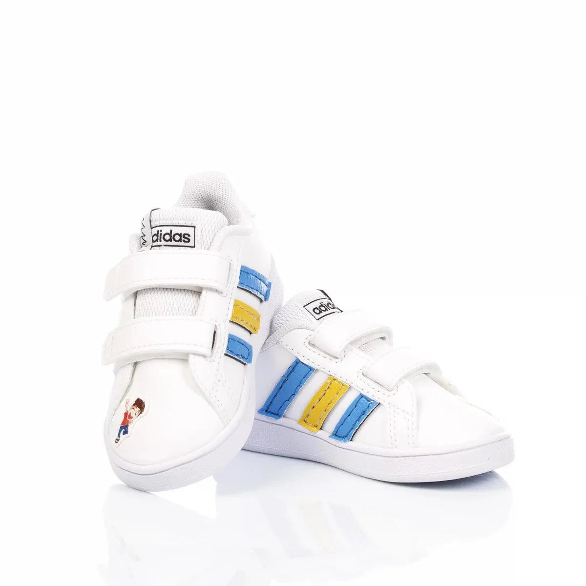 Scarpe da ginnastica bianche per bambini con strisce blu e gialle e chiusura a velcro