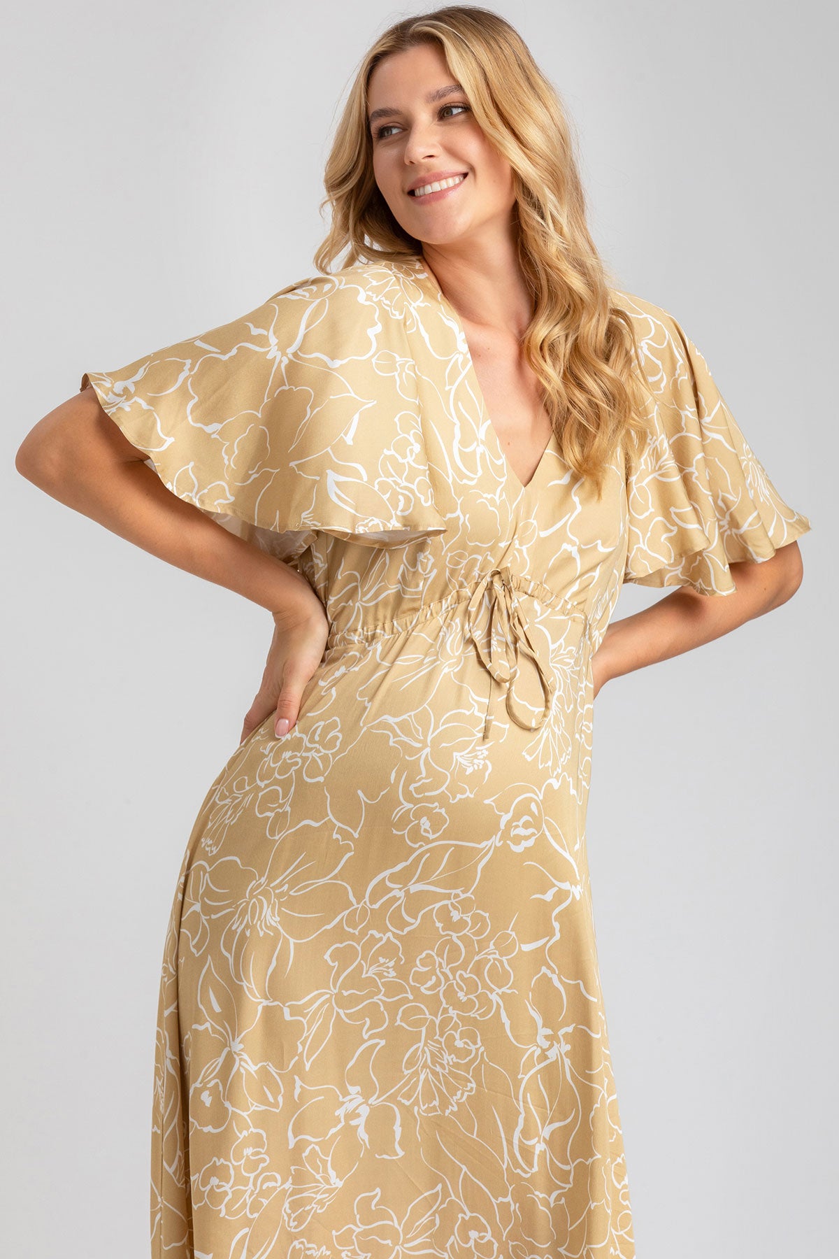Abito premaman elegante beige con fantasia floreale, maniche ampie e scollo a V