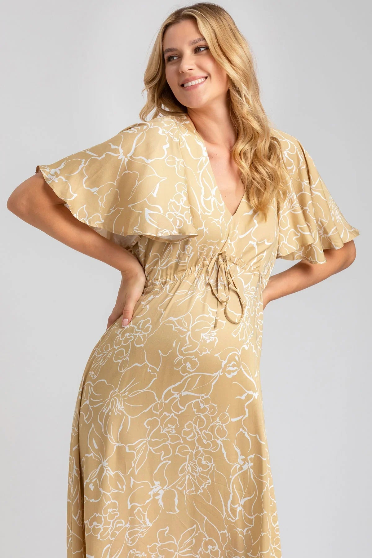 Abito premaman elegante beige con fantasia floreale, maniche ampie e scollo a V
