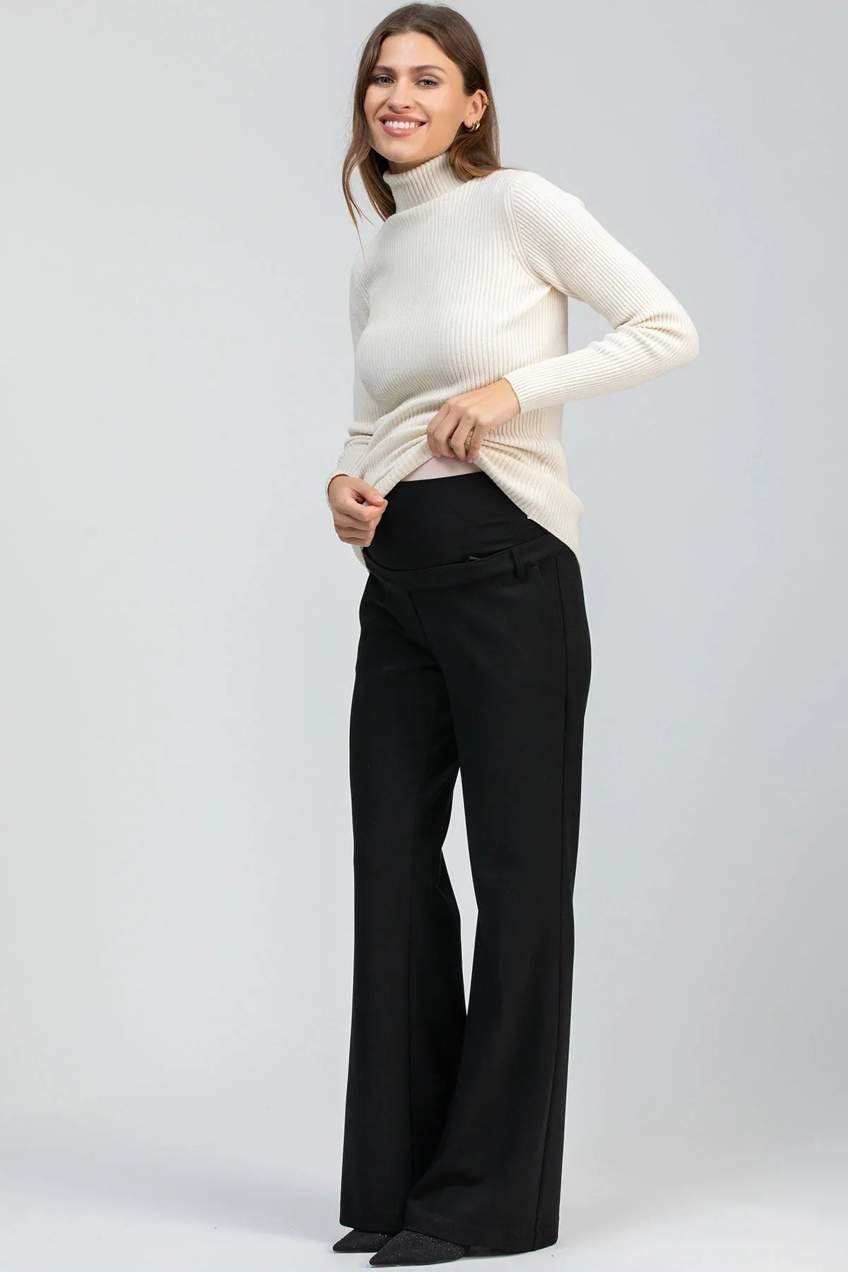 Cream ribbed maternity knit sweater with a fitted silhouette and long sleeves