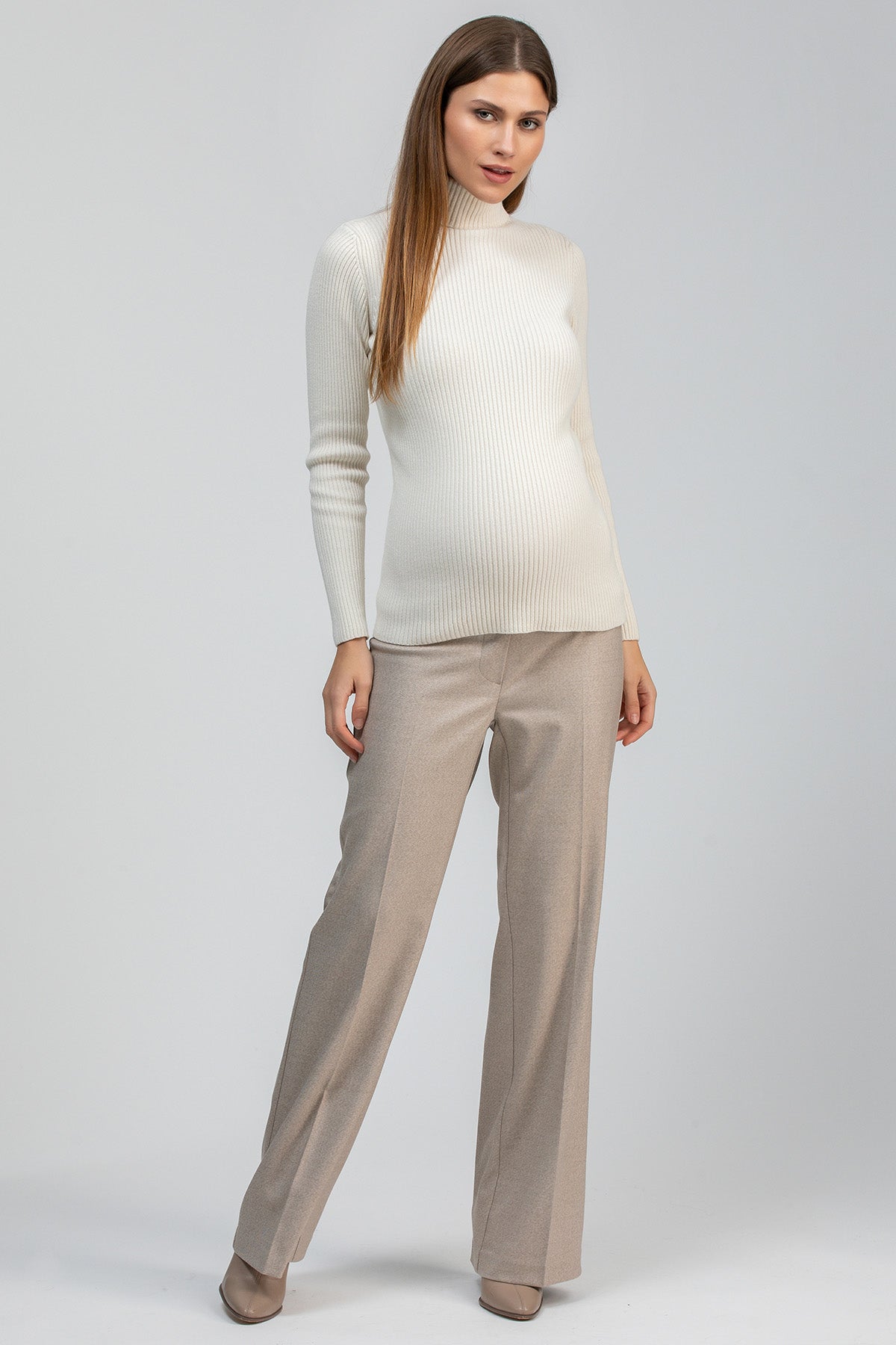 Cream ribbed maternity knit sweater with a fitted silhouette and long sleeves.