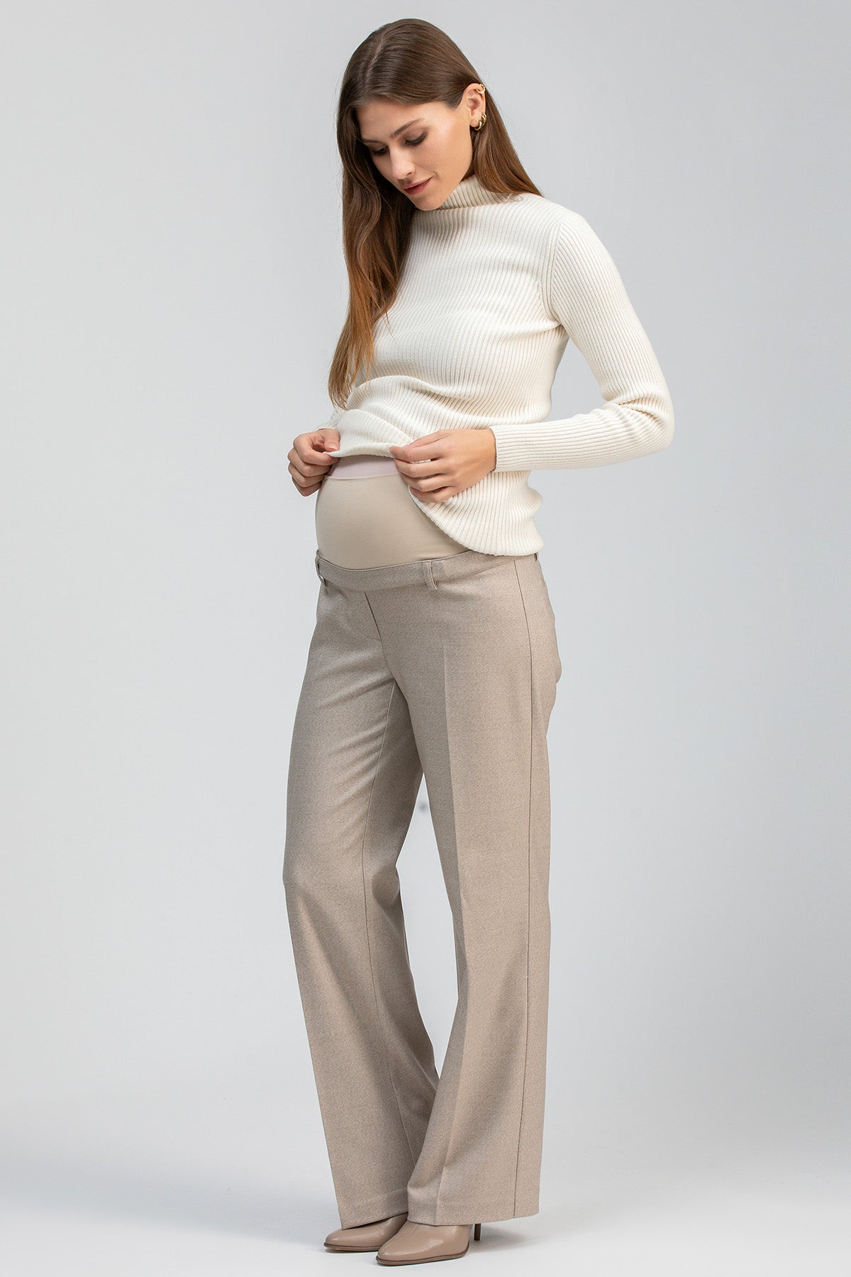 Cream fitted maternity sweater with long sleeves and a ribbed turtleneck