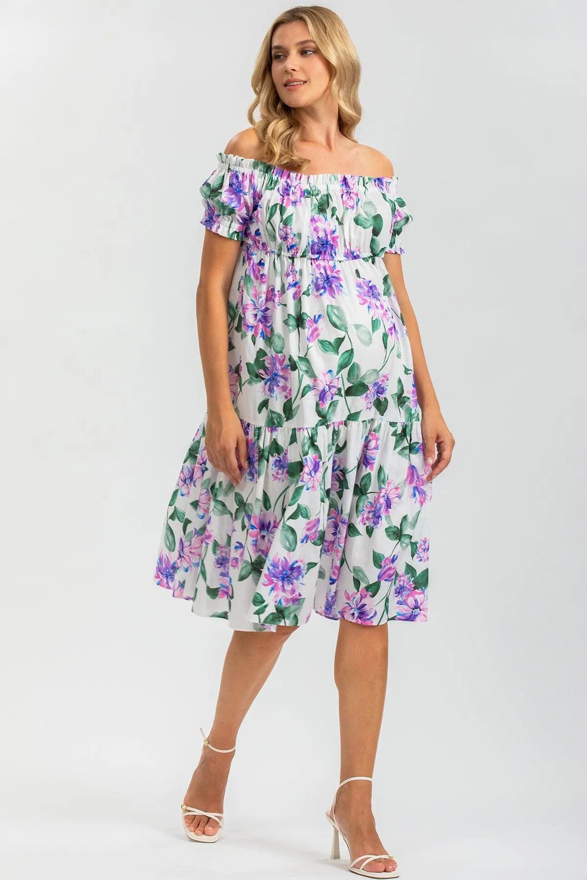Abito premaman estivo a fiori lilla e verdi, scollo bardot, tessuto leggero elegante.