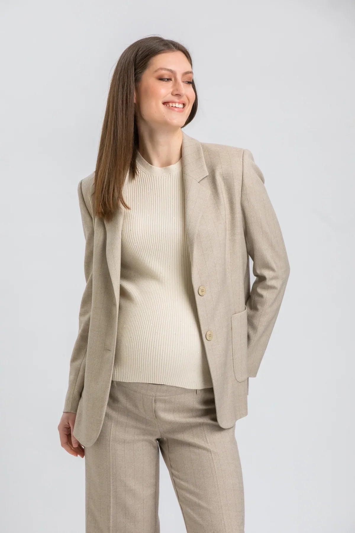 Elegant sand beige maternity suit with matching trousers.