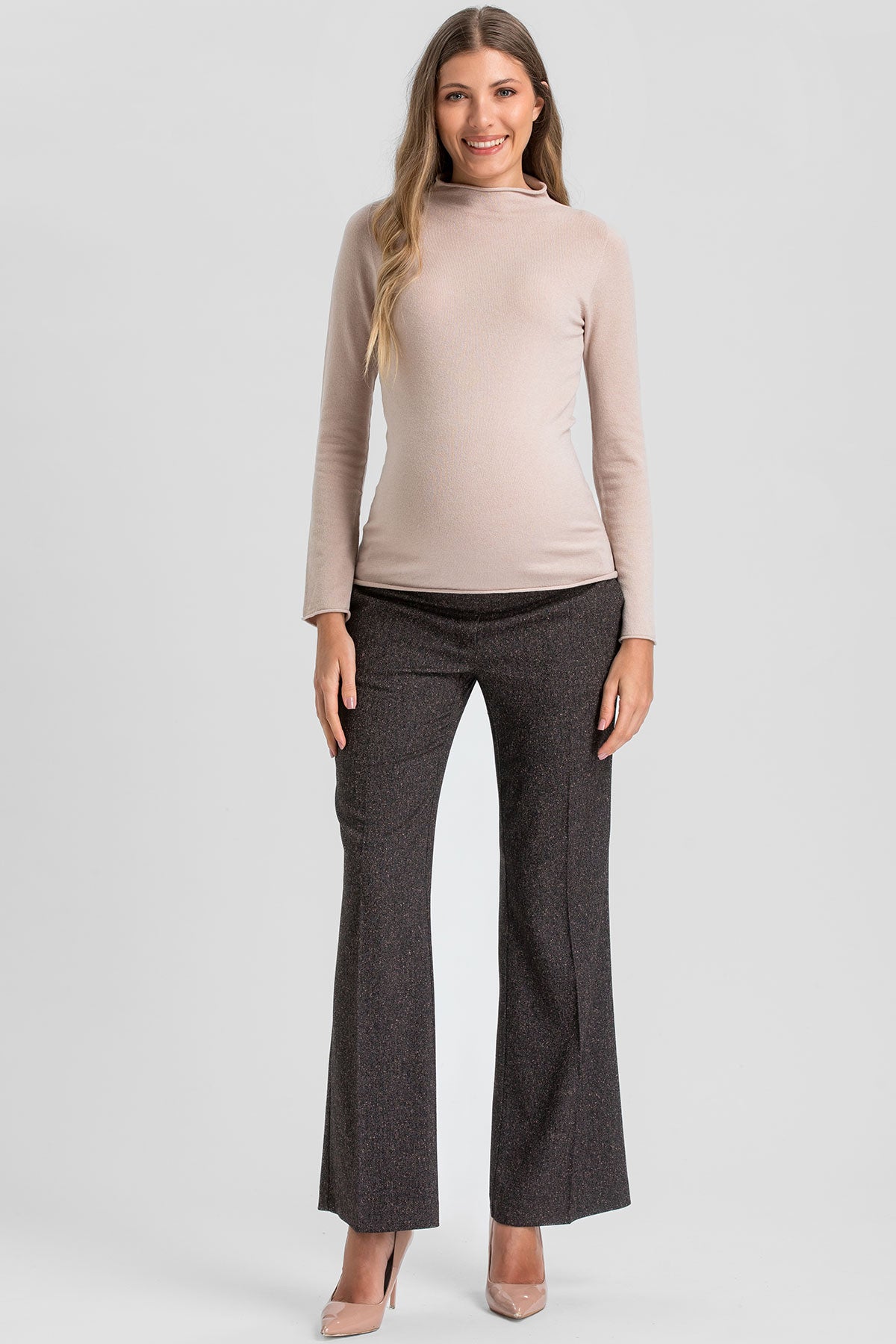 Fitted beige maternity top with long sleeves.